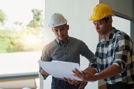 Professional architect designer structural engineer team colleagues discussing building plan design...