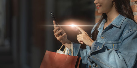 Asian fashionable woman walking at shopping mall with shopping bags while flash sale promotion