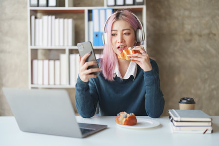 Young woman feeling excited at gaming on mobile phone, A gamer people playing video game online with smart mobile phoneの写真素材