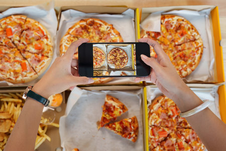 Friends at birthday party clinking glasses with champagne and pizza, enjoying Christmas vacation,...
