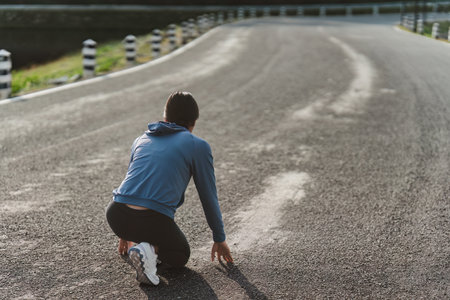Healthy Asian woman is jogging outdoor. Fitness girl running. Female exercising at outdoor parkの写真素材