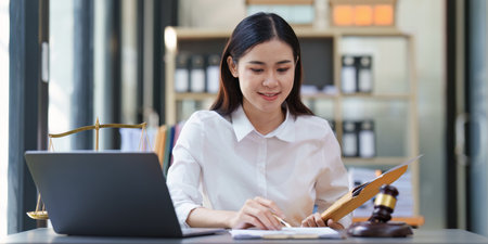 Lawyer working at office. Asian Lawyer doing with contract or document in office. Law, legal services, advice, Justice and real estate conceptの写真素材