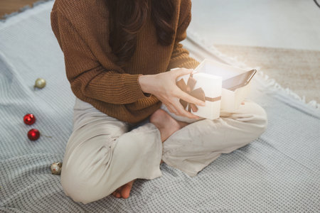 Cheerful lady surprised of the present after the opening in the gift box. Marry Christmas and Happy Holidays and New Year eve celebrating conceptの写真素材