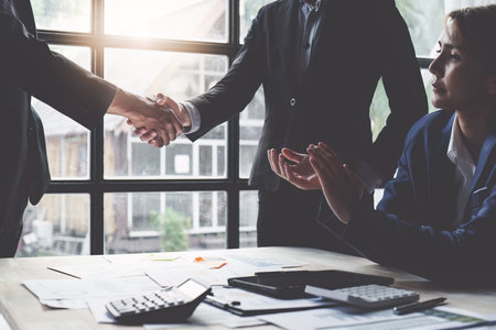 Business shaking hands. Successful businessmen handshaking after good deal. Finishing up meeting conceptの写真素材