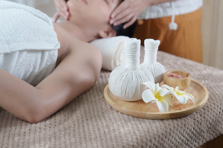 Young woman doing relaxing massage in spa salon. Female being massaged by a masseur. Spa and medicine conceptの写真素材