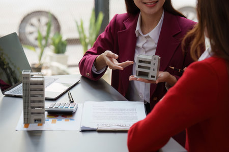 Real Estate Agent explain insurance and agreement contract to client before sign contract. Property insurance and security conceptの写真素材
