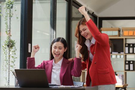Good teamwork result concept. Excited successful business people, celebrating win. Happy business team engaged in team building activity at corporate meetingの写真素材