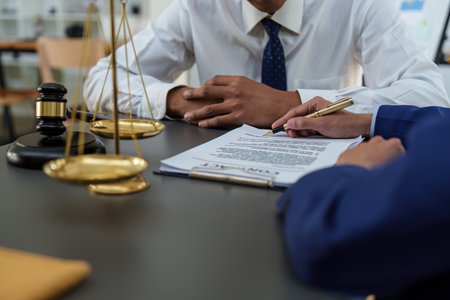 Business people and lawyers discussing contract papers with brass scale on wooden desk in office. Law, legal services, advice, Justice conceptの写真素材