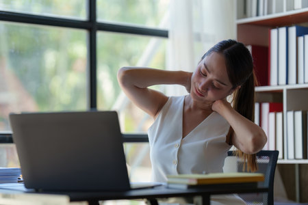 Asian Business woman working and relaxing at home office and analyze financial report document. Accounting and Finance conceptの写真素材