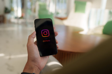 CHIANG MAI, THAILAND - FEB 12, 2023: Man hand using Iphone 14 with Instagram application on the screen by metaverse, Instagram is a photo-sharing app for smartphonesのeditorial素材