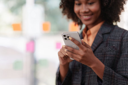 Accountant black woman working on smartphone and do document, tax, exchange, accounting and Financial advisor conceptの写真素材