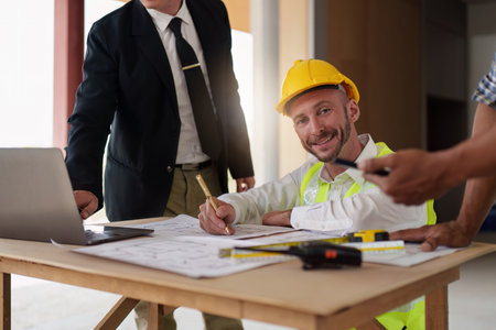 Civil Construction team working at renovate construction site. architectural plan, engineer sketching a construction project, green energy concept.の写真素材
