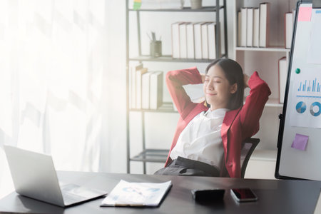 Asian Business woman working at home office and analyze financial report document. Accounting and Finance concept.の写真素材