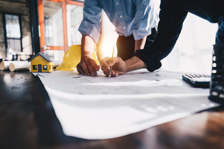 Architecture or Civil engineer team analyze with construction blueprint. plan, engineer sketching a...