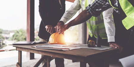 Foreman or Civil engineer put their hand to working together. industry professional team and engineer conceptの写真素材