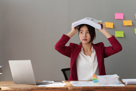 Tired business woman in stress works with many paperwork document. migraine attack. Freelance, work...