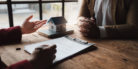 Close up Business people or Real Estate agent explain signing agreement for sale house to client. Property, Insurance, Broker conceptの写真素材