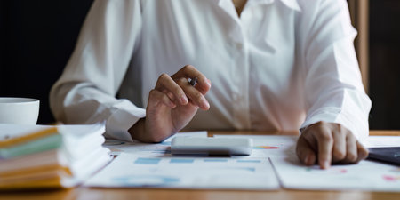 Business person analysis and research with financial graph at home office. Strategy, chart, finance report conceptの写真素材