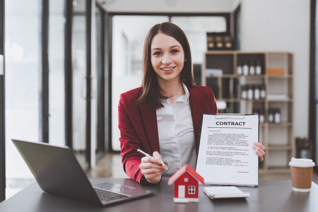 Business person or Real Estate agent explain signing agreement for buying house. Bank manager and real estate concept.の写真素材