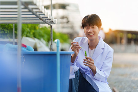 Science team working and researching in hydro and organic farm. Quality check, laboratory greenhouse concept.の写真素材