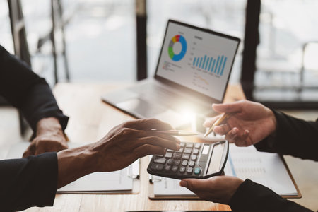 Business People Meeting Research finance report by laptop. management strategy analysis financial accounting conceptの写真素材