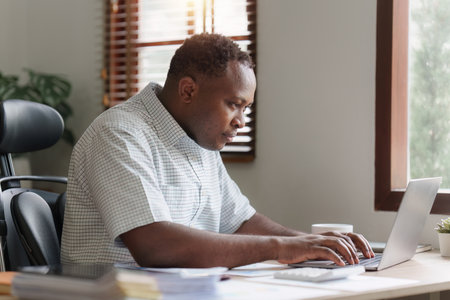 American African Businessman research and analysis with financial graph at office. Strategy, chart,...