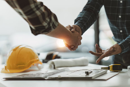Foreman or Civil engineer handshake making modern construction. industry professional team and engineer conceptの写真素材