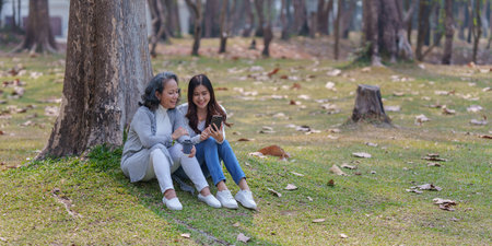 Adult daughter and her elderly mother have outdoor activity together