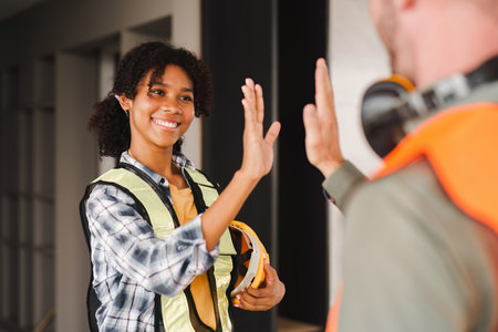 Foreman or Skillful worker team celebrate success at construction site. Industrial people and manufacturing labor conceptの写真素材