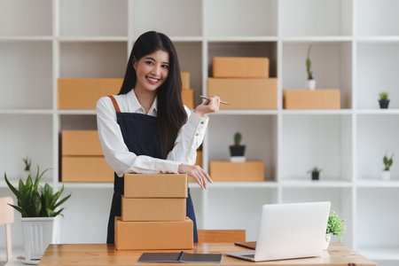 Small businesses SME owners female entrepreneurs check online orders to prepare to pack the boxes, sell to customers, sme business ideas onlineの写真素材