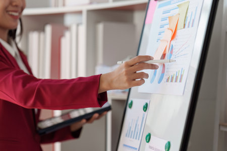 Beautiful Business woman analysis and research with financial graph at home office. Strategy, chart, finance report conceptの写真素材