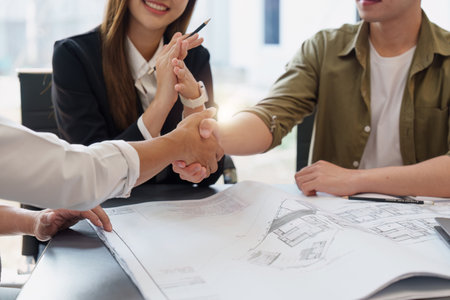 Architecture and Civil engineer handshake making modern construction. industry professional team and engineer conceptの写真素材
