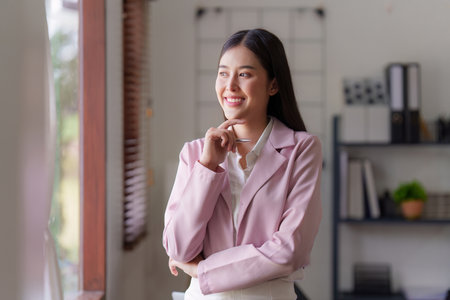 Asian Business person makes analysis and research financial report at office, analyzes profits. Accountant checks status of financialの写真素材