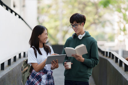 Young Asian woman college student with friends at outdoors. College student working on the college campus, education, school, studyの写真素材