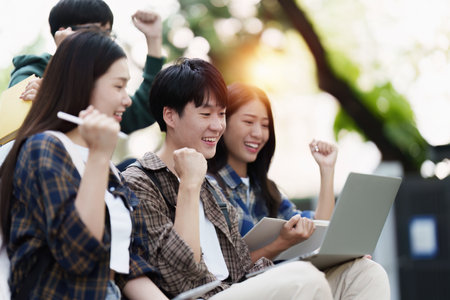 Young Asian woman college student with friends at outdoors. College student working on the college campus, education, school, studyの写真素材