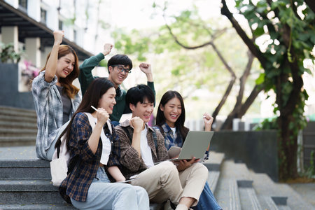 Young Asian woman college student with friends at outdoors. College student working on the college campus, education, school, studyの写真素材