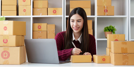 Small businesses SME owners female entrepreneurs check online orders to prepare to pack the boxes, sell to customers, sme business ideas onlineの写真素材