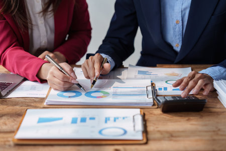 Group of Business People Meeting analysis financial plan, discussion, research with paperwork at...