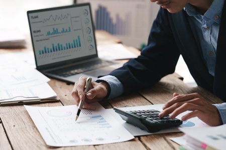 Close up Accountant man working with calculator and do document, tax, exchange, accounting and Financial advisor conceptの写真素材