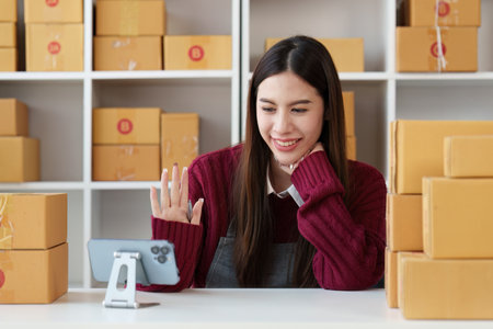 Small businesses SME owners female entrepreneurs check online orders to prepare to pack the boxes, sell to customers, sme business ideas onlineの写真素材