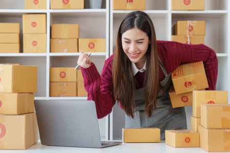 Small businesses SME owners female entrepreneurs check online orders to prepare to pack the boxes, sell to customers, sme business ideas onlineの写真素材