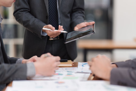 Close up of Diverse colleagues gather brainstorm discuss financial statistics at office meeting. finance, teamwork, Big data Graphs Charts conceptの写真素材