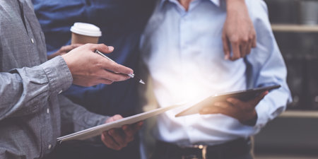 Close up of Diverse colleagues gather brainstorm discuss financial statistics at office meeting. finance, teamwork, Big data Graphs Charts conceptの写真素材