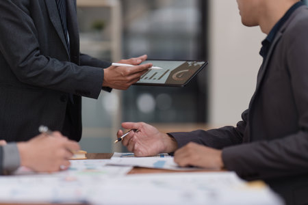 Close up of Diverse colleagues gather brainstorm discuss financial statistics at office meeting. finance, teamwork, Big data Graphs Charts conceptの写真素材