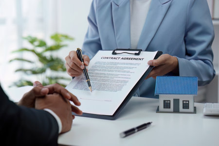 Close up Business people or Real Estate agent explain signing agreement for sale house to client. Property, Insurance, Broker conceptの写真素材