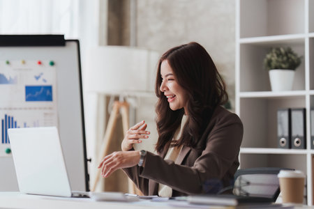 Confident business person executive using laptop computer, having video conference call virtual meeting, advisor finance, research, fundの写真素材