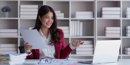 Accountant asian woman working on laptop and do document, tax, exchange, accounting and Financial advisor conceptの写真素材