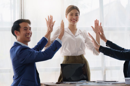 Group of Business People Meeting and Corporate partnership and achievement concept. Business people celebrate when successful work projectの写真素材