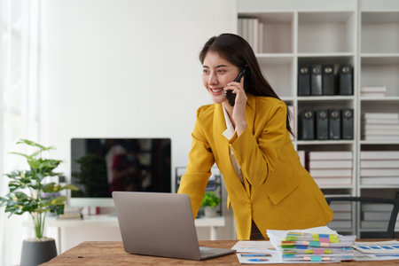 Beautiful business woman talking on the mobile phone. Management, planning and networking phone call conceptの写真素材