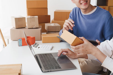 Small business owners couple entrepreneurs working with parcel, e-business, marketing, online shop,...